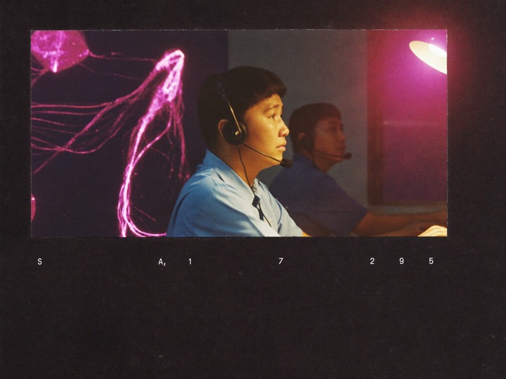 A support agent wearing a headset at a desk in a quiet operations room